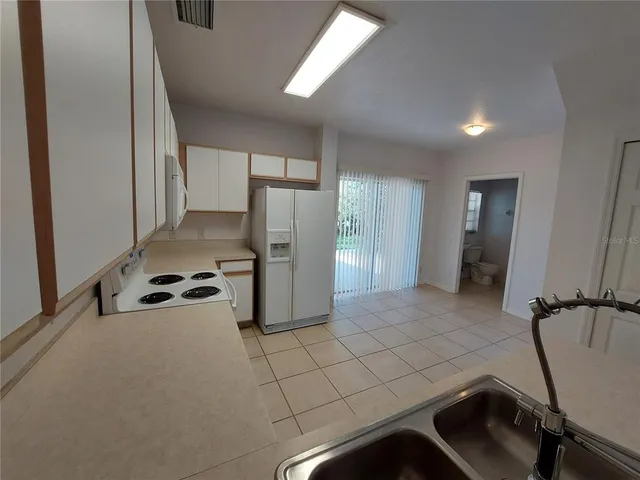 a kitchen with a refrigerator and a sink