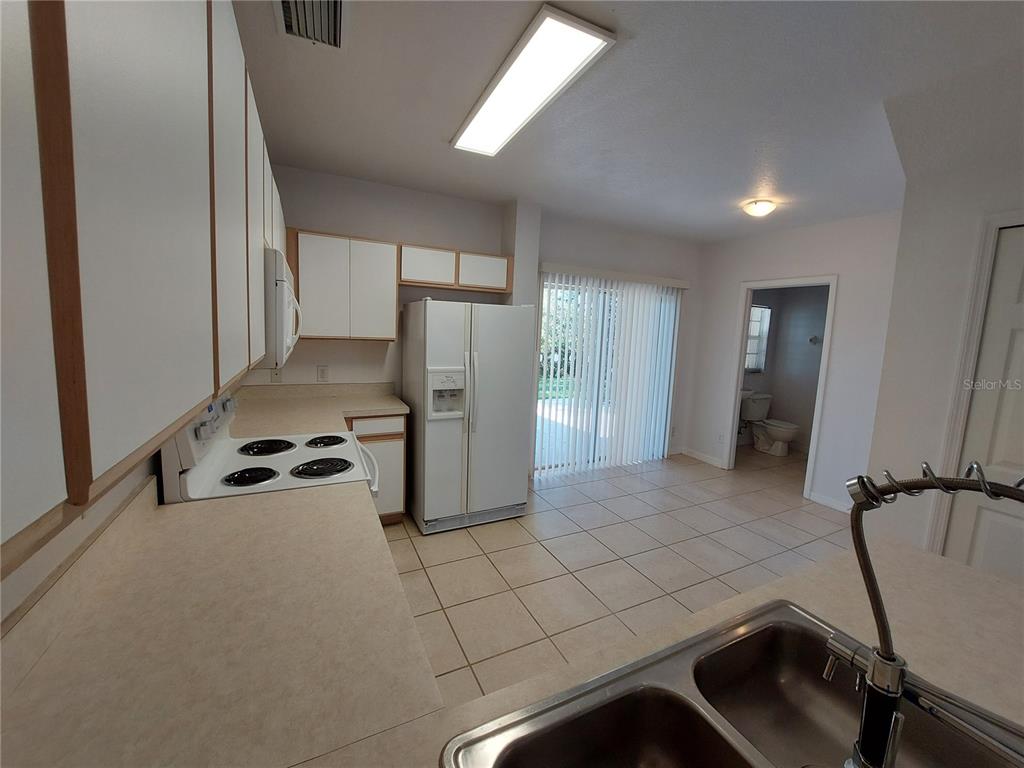 3521 Red Rock Drive Land O Lakes, FL 34639 - Photo 3 of 13 a kitchen with a refrigerator and a sink