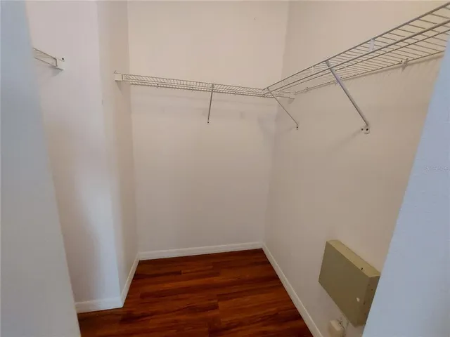 a view of a room with wooden floor and white walls