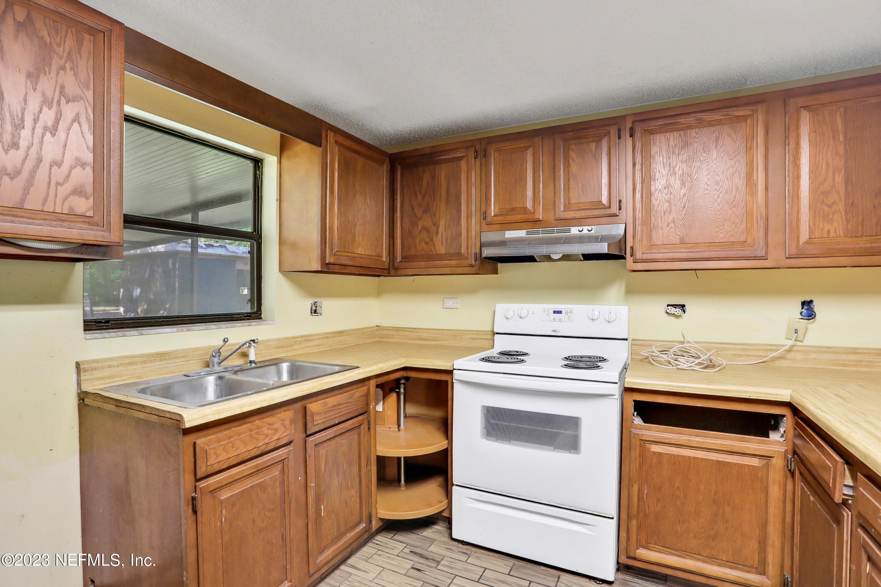 4053 Appaloosa Road Middleburg, FL 32068 - Photo 6 of 36 a kitchen with a sink stove and cabinets