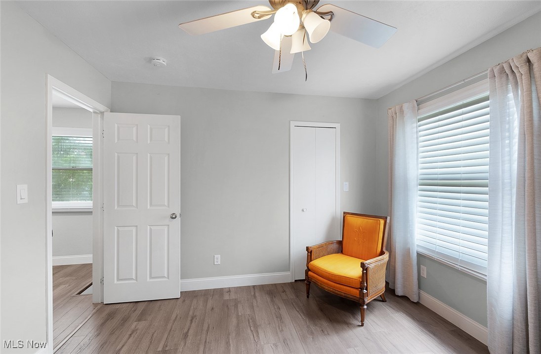 3913 Silsby Road Cleveland, OH 44118 - Photo 24 of 26 Living area featuring light wood-style floors, ceiling fan, and baseboards