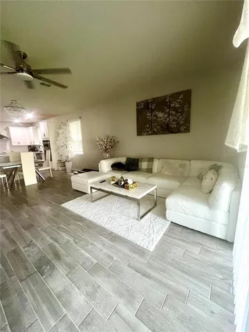 a view of room with wooden floor and flat screen tv