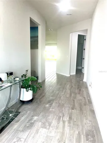 a kitchen with granite countertop a refrigerator stove top oven and sink