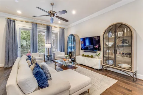a living room with furniture a fireplace and a chandelier