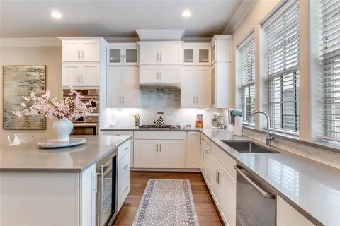a kitchen with cabinets a sink and appliances