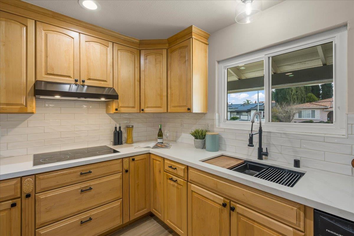 6535 Kings Place Gilroy, CA 95020 - Photo 12 of 25 a kitchen with stainless steel appliances a sink stove and cabinets