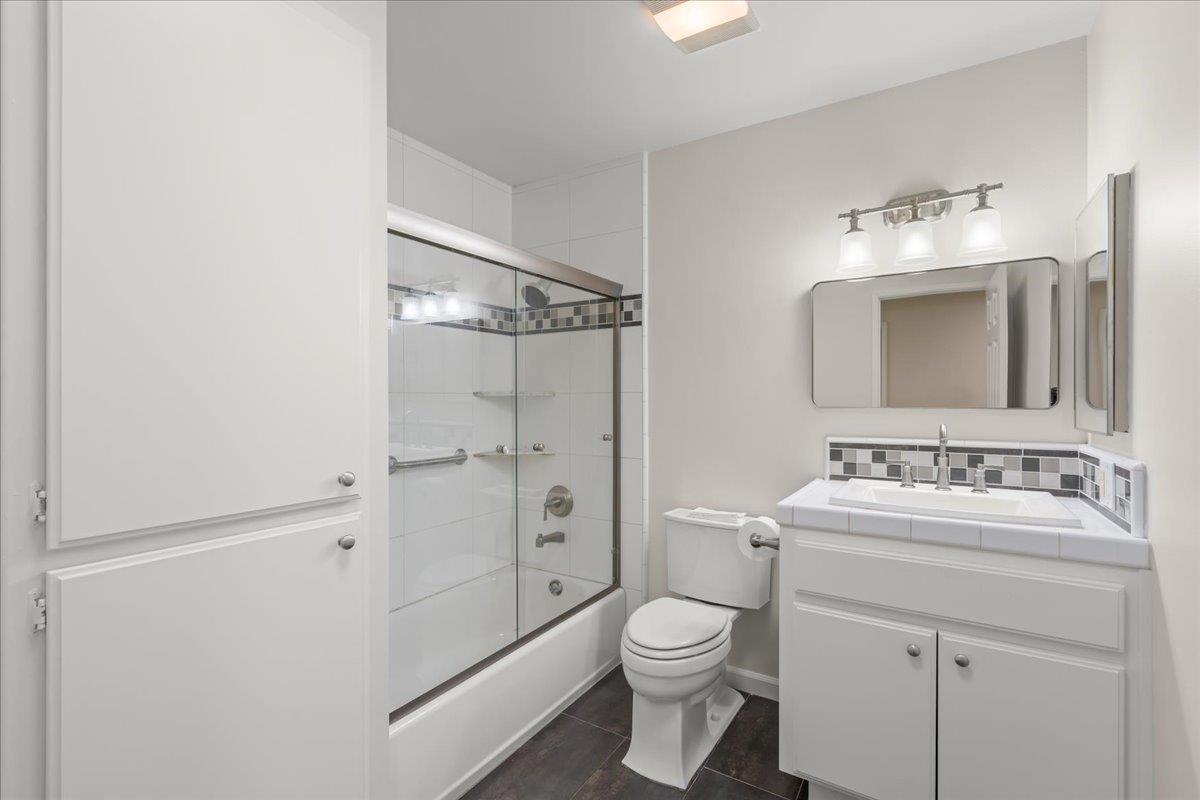 6535 Kings Place Gilroy, CA 95020 - Photo 21 of 25 a bathroom with a toilet a sink a mirror and shower