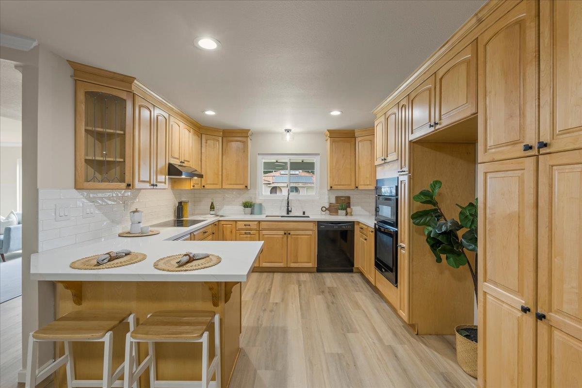 6535 Kings Place Gilroy, CA 95020 - Photo 9 of 25 a kitchen with a sink a counter top space stainless steel appliances and cabinets