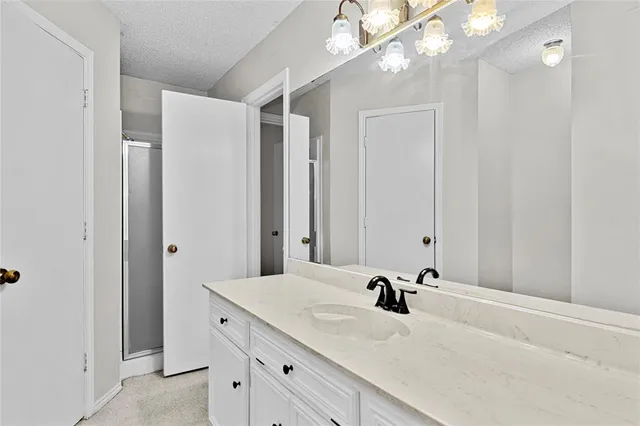 a bathroom with a sink vanity and a mirror