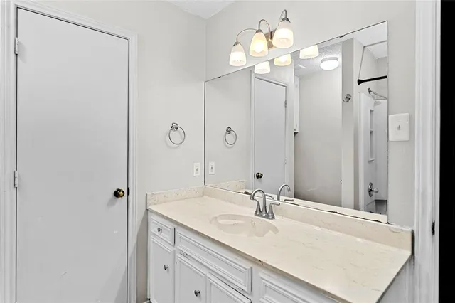 a bathroom with a sink vanity and a mirror