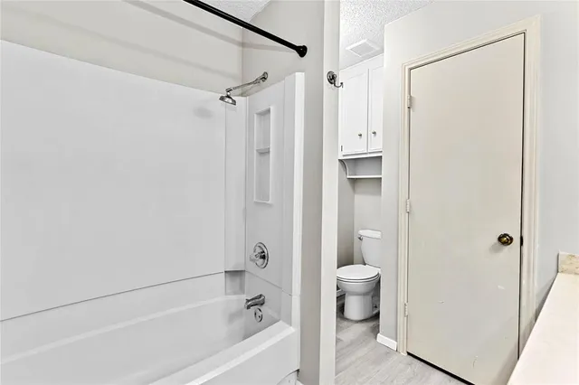 a bathroom with a shower and a toilet