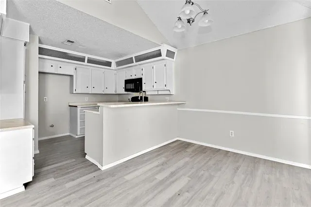 a view of a kitchen with electric appliances