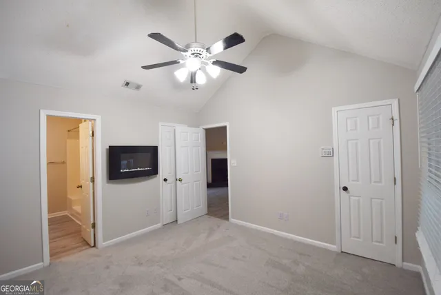a view of a livingroom with a chandelier fan