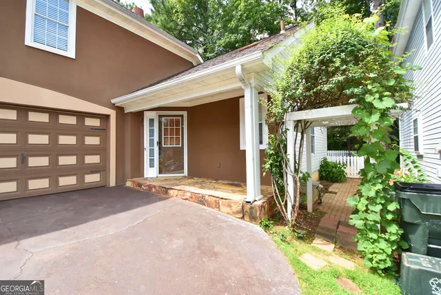 a front view of a house with a yard outdoor seating and garage
