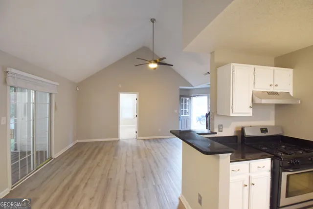 a kitchen with a sink a stove and cabinets