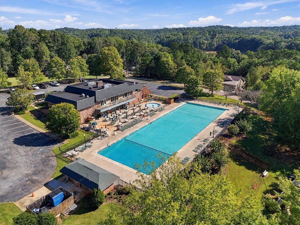 211 Cedar Ridge Drive Westminster, SC 29693 - Photo 31 of 34 A sweeping aerial view reveals a vast community swimming pool nestled among dense green woods.