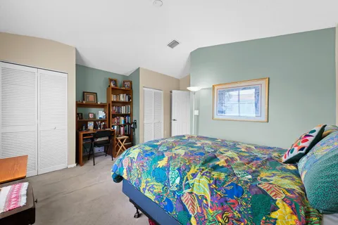 a bedroom with a bed and a bookshelf