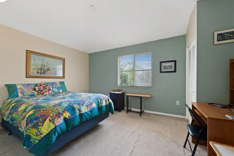 a bedroom with a bed a desk and chair