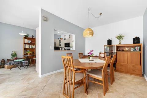 a dining room with furniture and chandelier