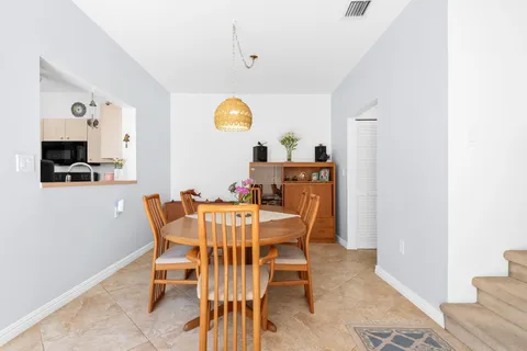 a view of a dining room with furniture and a flat screen tv
