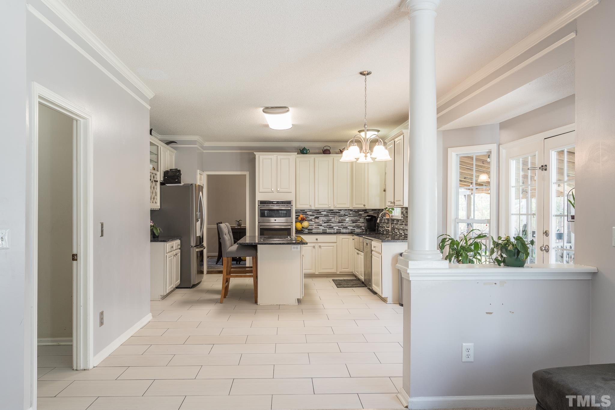 4900 Goosedown Court Raleigh, NC 27604 - Photo 20 of 41 Open to the family room, this recently updated kitchen has a breakfast area and island.