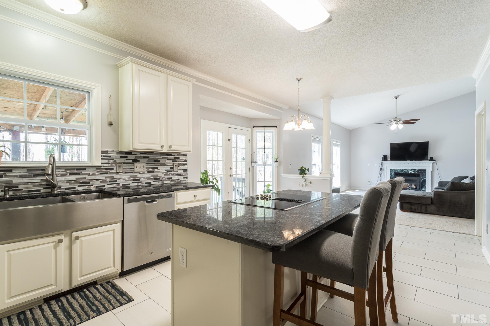 4900 Goosedown Court Raleigh, NC 27604 - Photo 25 of 41 New countertops and tile backsplash take center stage in this recently upgraded kitchen.