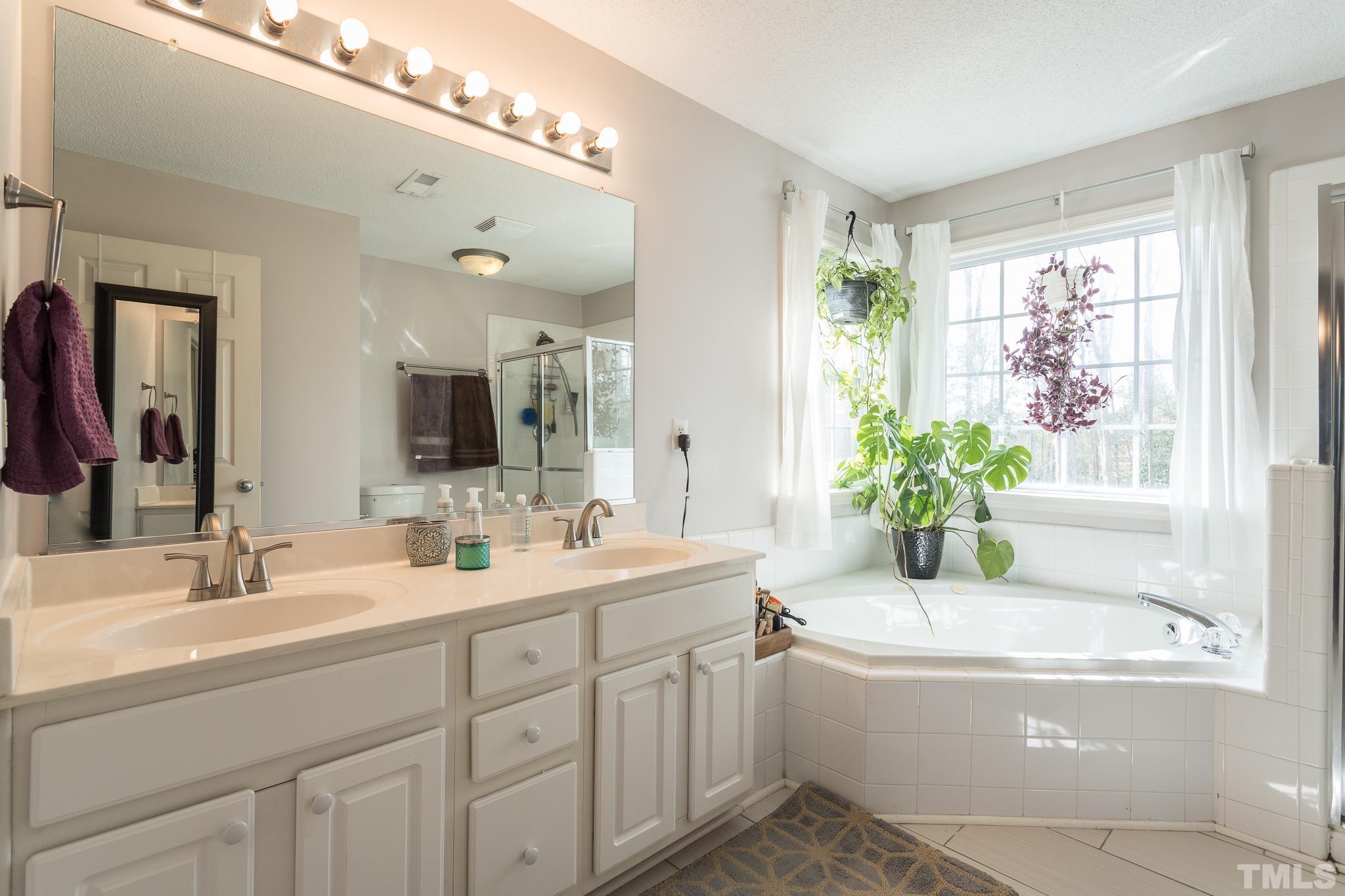 4900 Goosedown Court Raleigh, NC 27604 - Photo 39 of 41 A beautiful master bathroom with dual vanity, a soaking tub and separate shower.