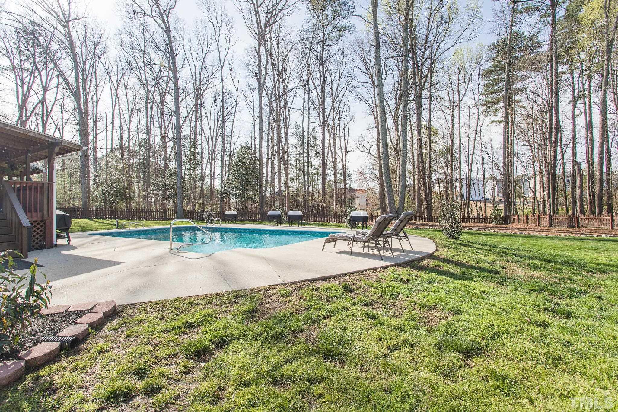4900 Goosedown Court Raleigh, NC 27604 - Photo 4 of 41 The backyard is beautifully landscaped with an abundance of fruit trees and new garden boxes, as well as a pool and spa.