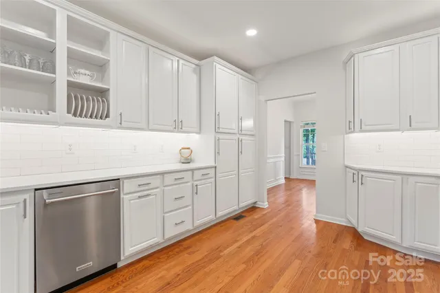 a kitchen with granite countertop white cabinets and white appliances