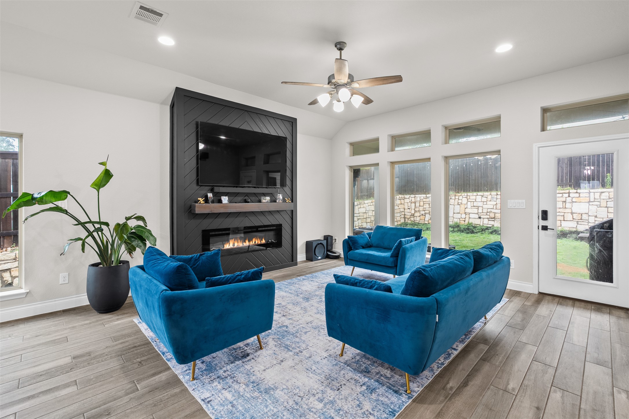 341 Pisa Lane Georgetown, TX 78628 - Photo 4 of 31 a living room with furniture a potted plant and a fireplace