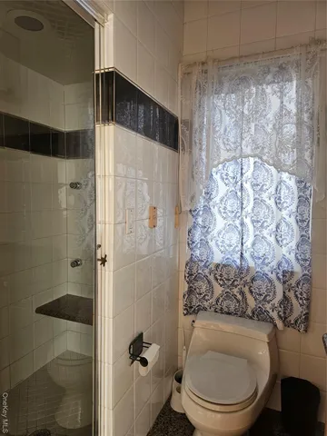 a bathroom with a toilet and shower