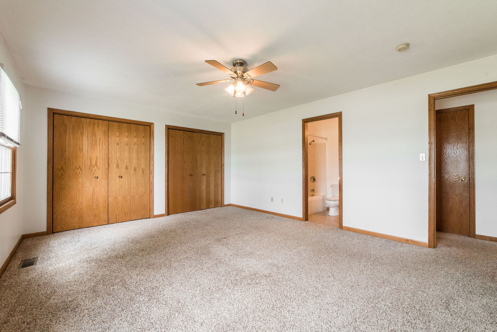434 South Peace Road, Unit 434 Sycamore, IL 60178 - Photo 14 of 22 a view of an empty room with a ceiling fan and a window