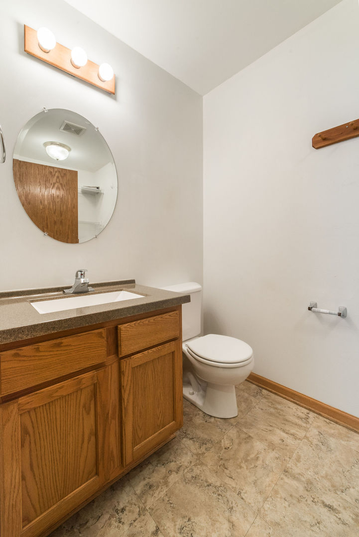 434 South Peace Road, Unit 434 Sycamore, IL 60178 - Photo 19 of 22 a bathroom with a toilet a sink and mirror