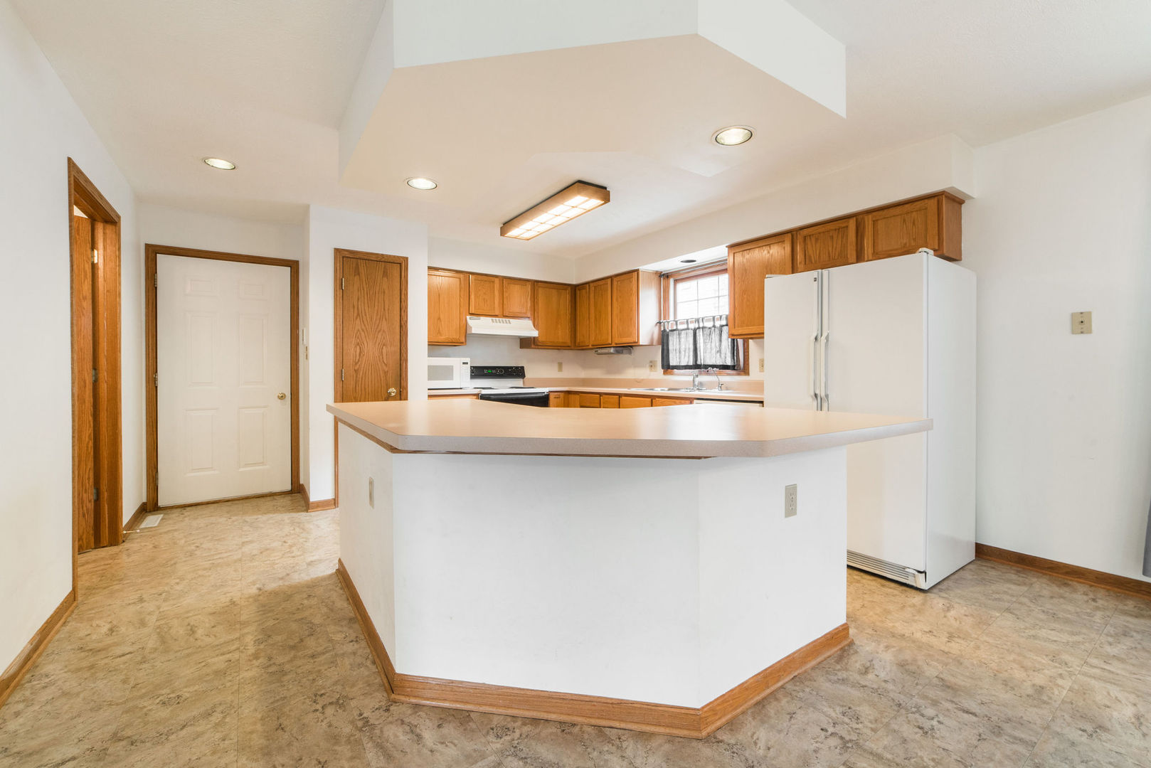 434 South Peace Road, Unit 434 Sycamore, IL 60178 - Photo 7 of 22 a kitchen with stainless steel appliances granite countertop a refrigerator and a sink