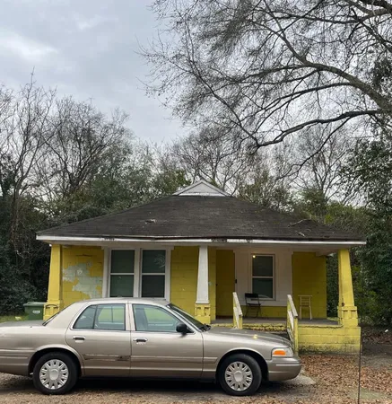 a front view of a house with car parked