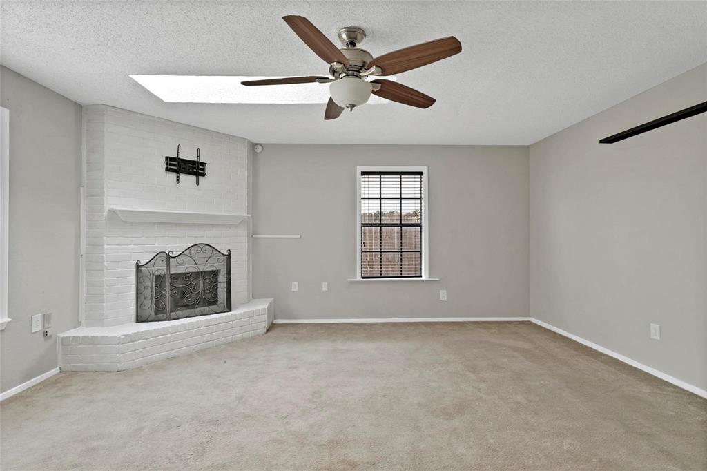 6104 Kelly Elliott Road Arlington, TX 76001 - Photo 17 of 25 an empty room with fireplace and windows