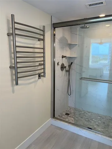 a bathroom with a glass shower door