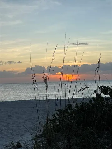 a view of a balcony with chairs and wooden floor