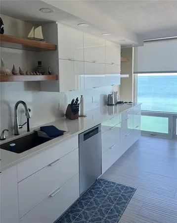 a kitchen with a sink and cabinets