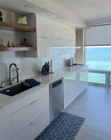a kitchen with a sink and cabinets