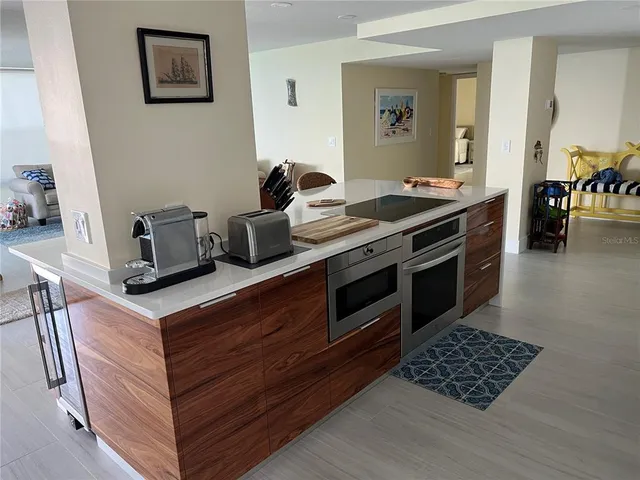a kitchen with stainless steel appliances granite countertop a stove and a cabinets