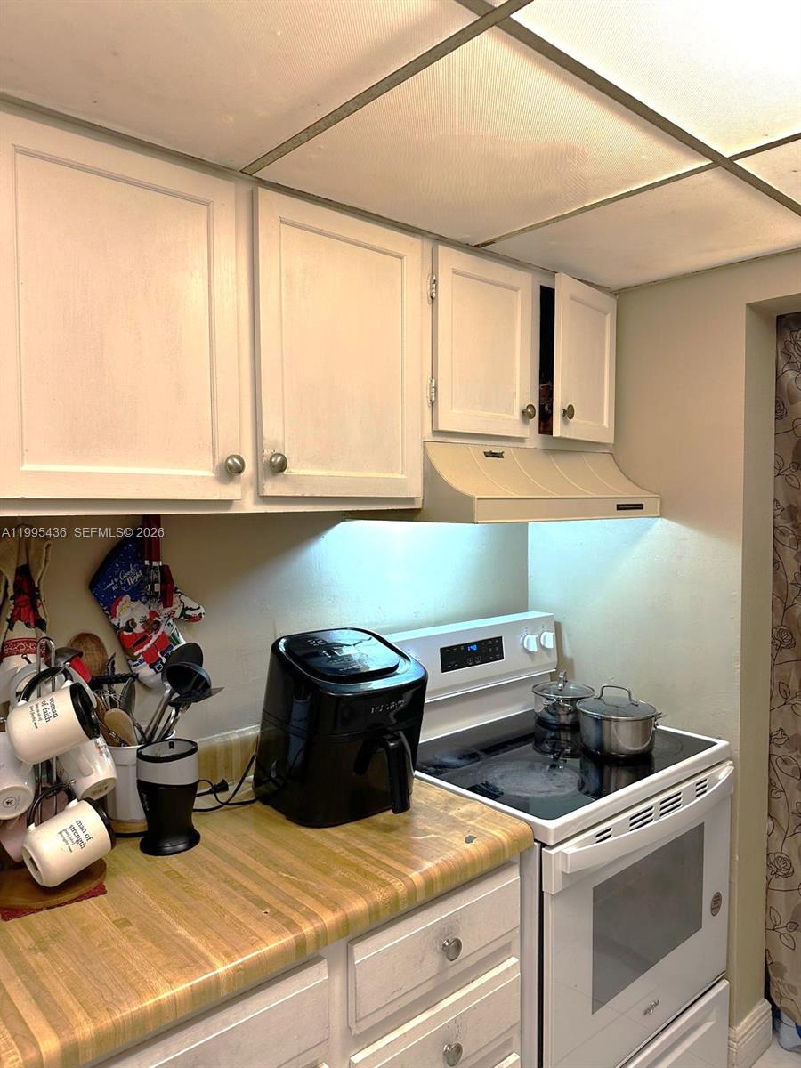 3720 Inverrary Drive, Unit 1J Lauderhill, FL 33319 - Photo 16 of 24 a kitchen with a stove and a microwave