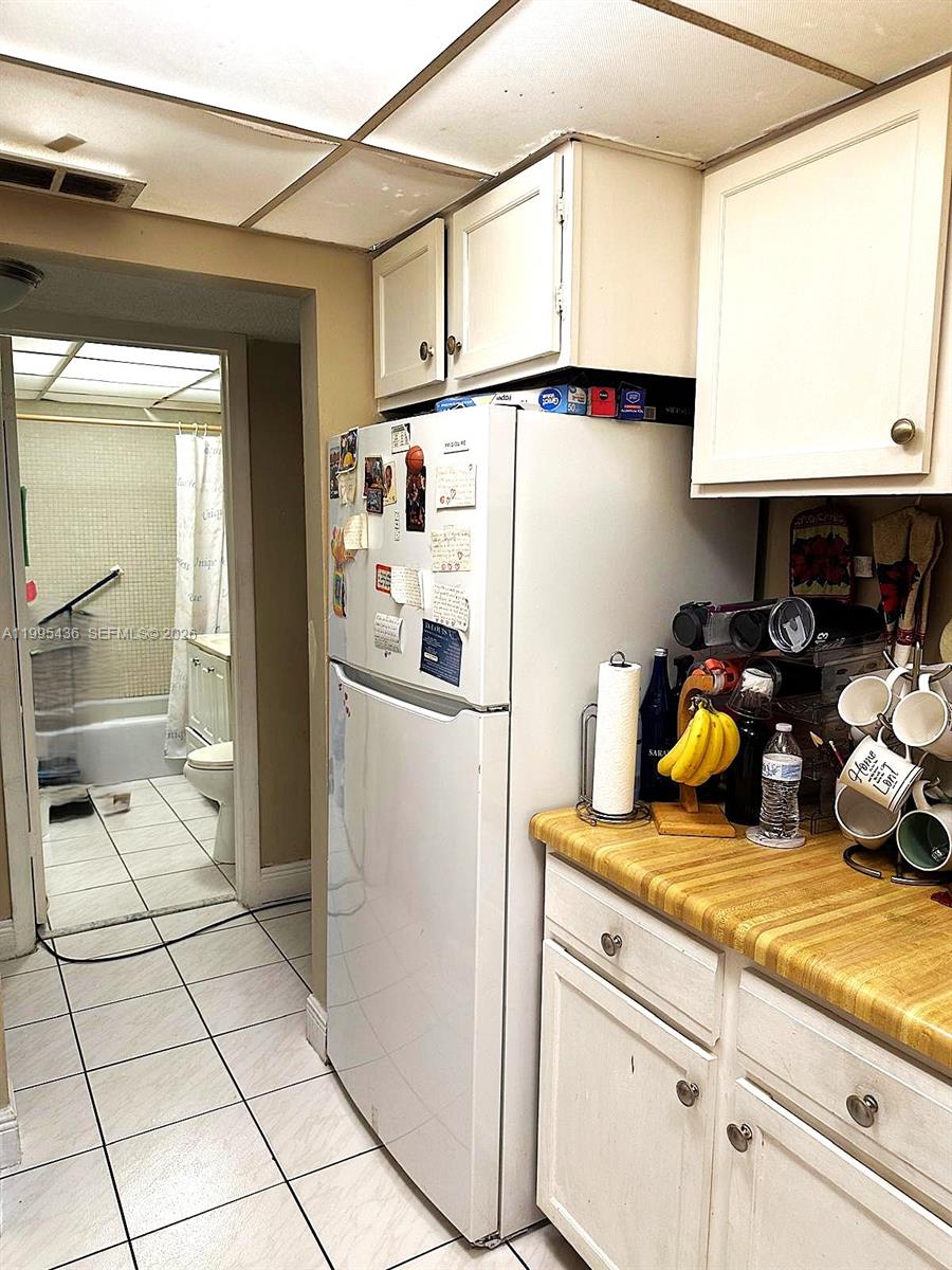 3720 Inverrary Drive, Unit 1J Lauderhill, FL 33319 - Photo 17 of 24 a kitchen with stainless steel appliances granite countertop a refrigerator and a sink