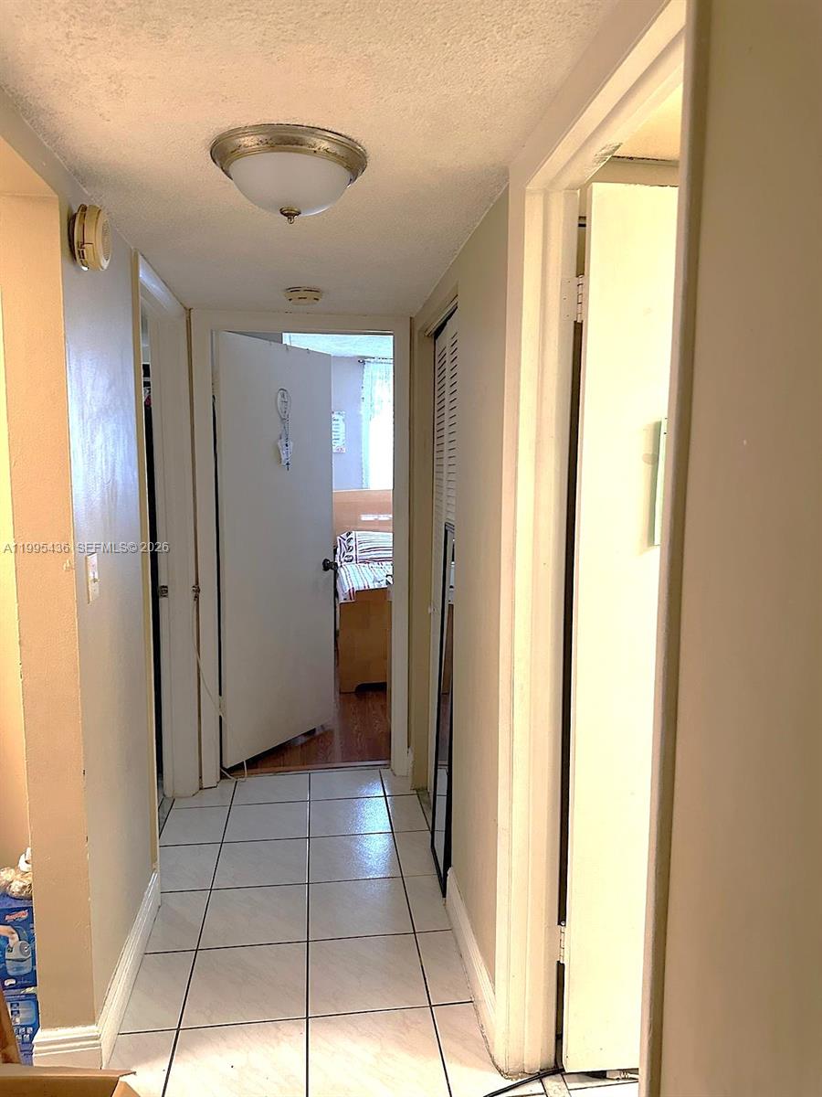 3720 Inverrary Drive, Unit 1J Lauderhill, FL 33319 - Photo 18 of 24 a view of a hallway with a bathroom