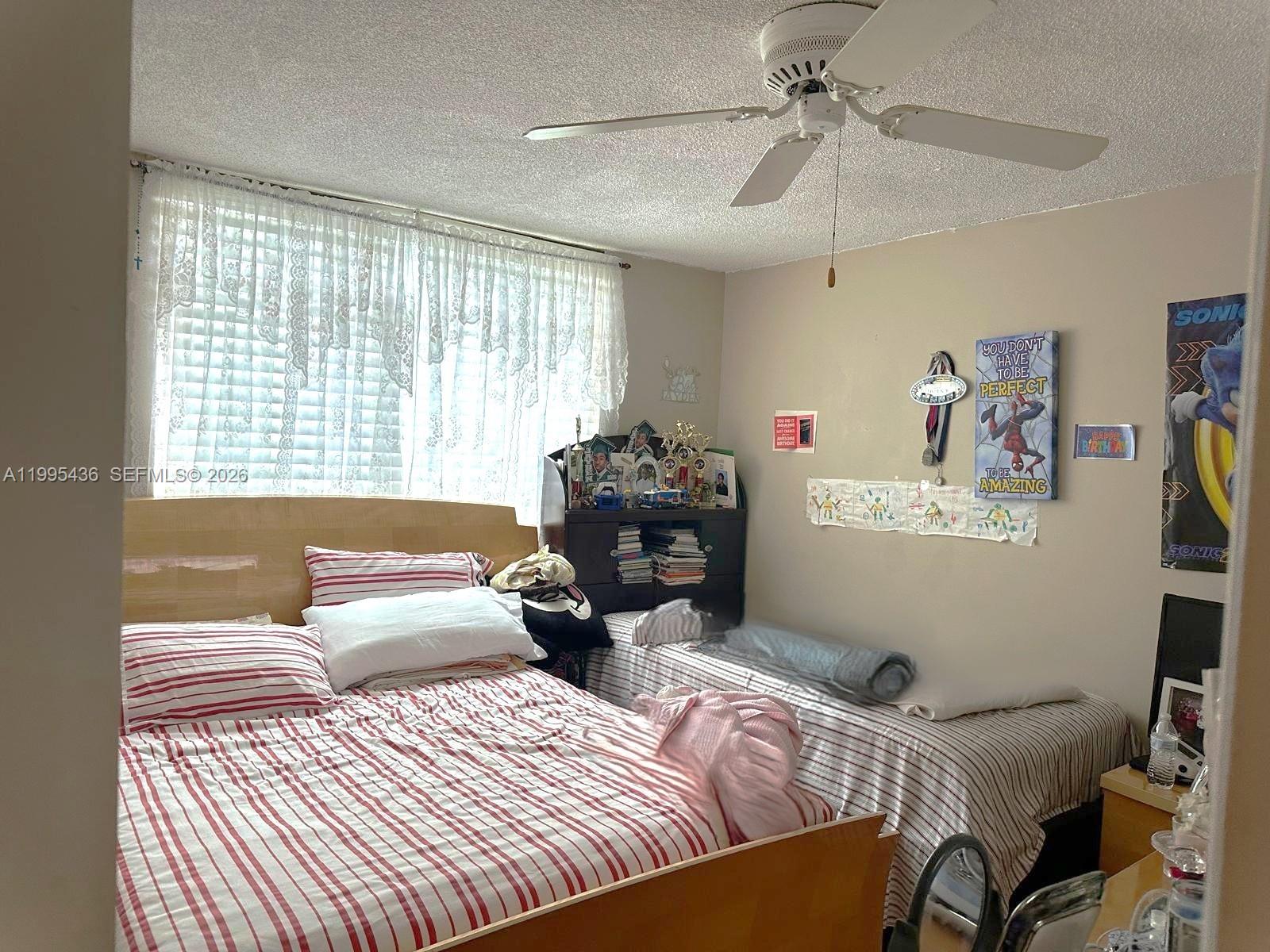 3720 Inverrary Drive, Unit 1J Lauderhill, FL 33319 - Photo 19 of 24 a bedroom with furniture and a window