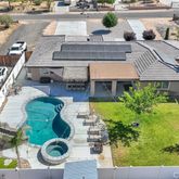 an aerial view of a house with yard swimming pool and outdoor seating