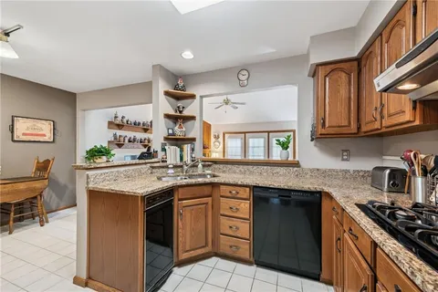 a kitchen with a sink stove and cabinets