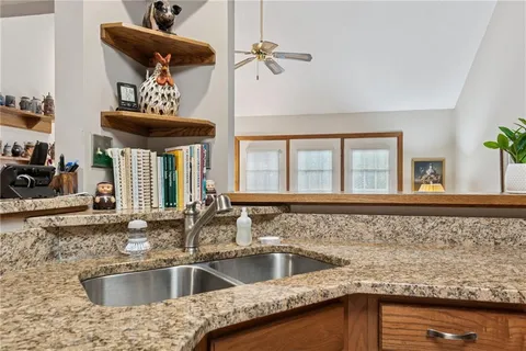 a kitchen with a sink cabinets and a window