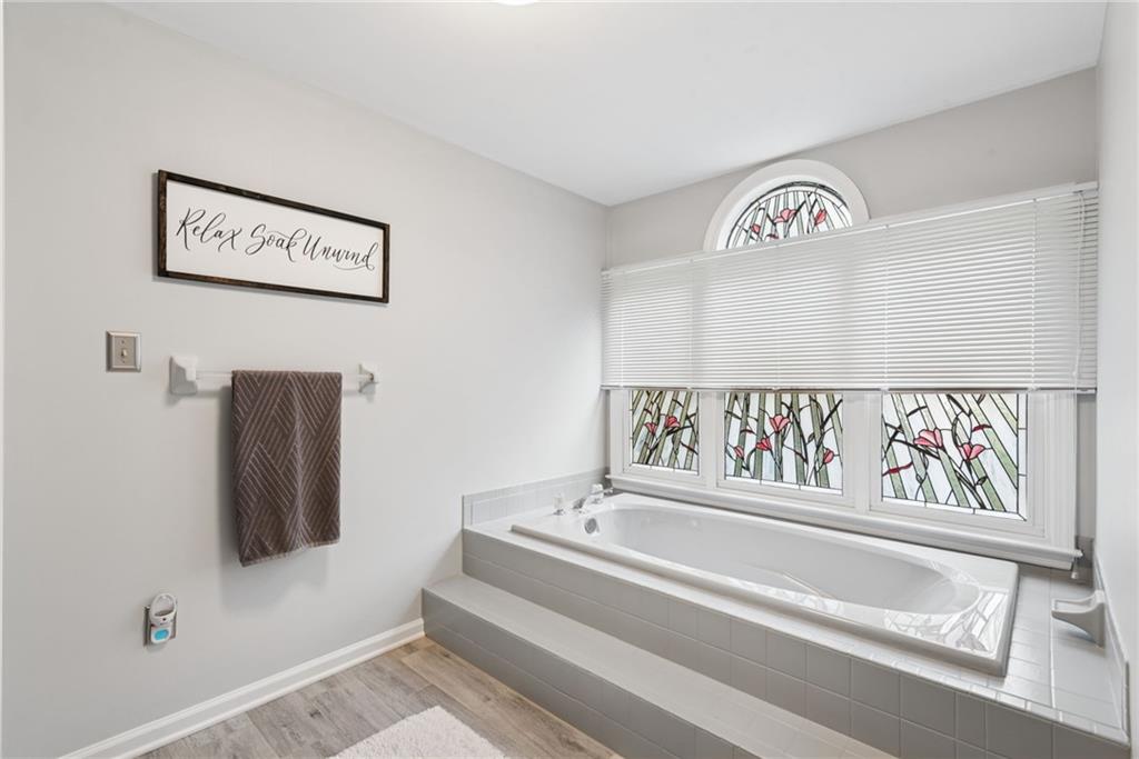 601 Timber Lane Sewickley, PA 15143 - Photo 24 of 45 a bathroom with a bathtub and a window