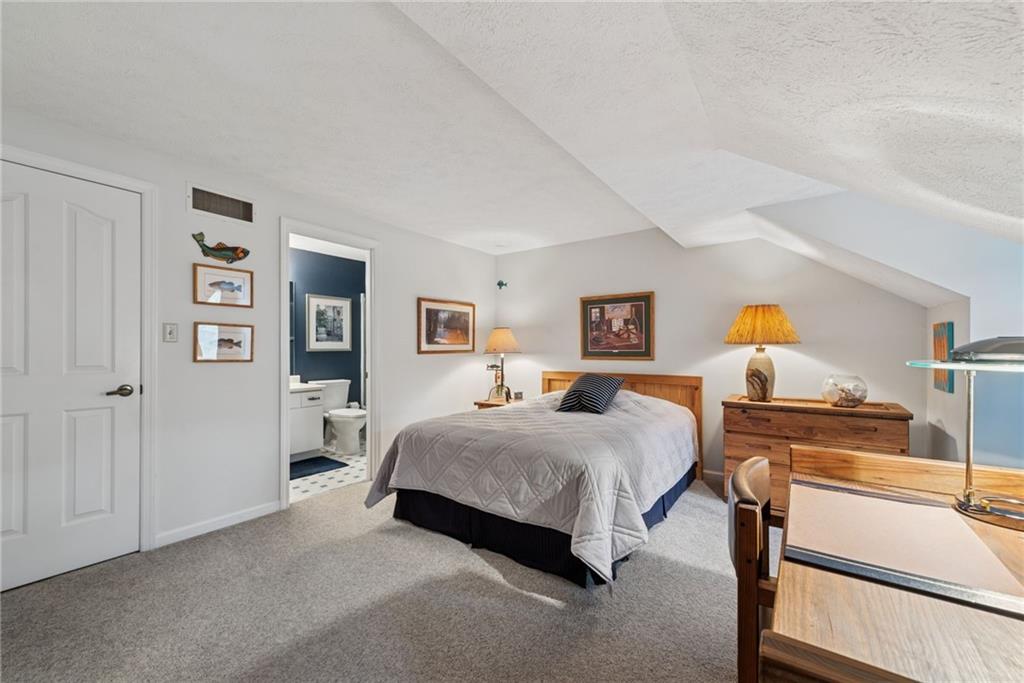 601 Timber Lane Sewickley, PA 15143 - Photo 25 of 45 a spacious bedroom with a bed and wooden floor